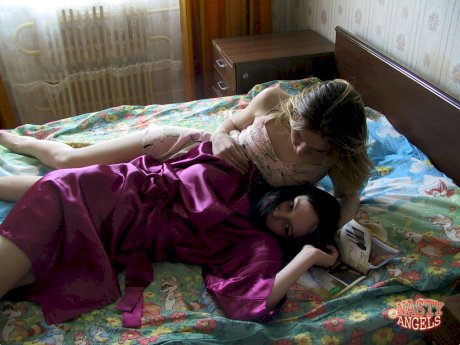 Naughty amateur teens Alina & Marina cuddle in bed after taking a shower