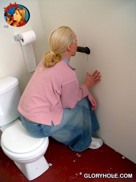 Blonde girl Jamie sits on the toilet and blows a black gloryhole dong