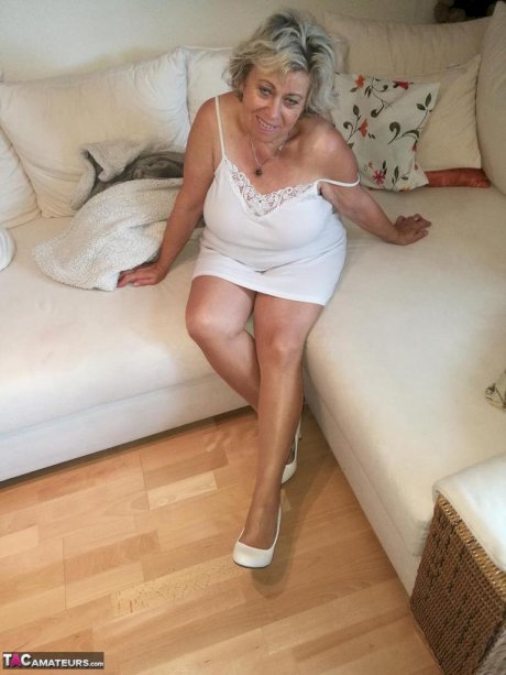 Horny grandmother slides hands down pantyhose to masturbate