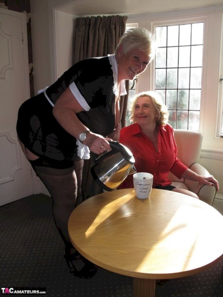 Fat mature maid serves her guests while wearing revealing clothing