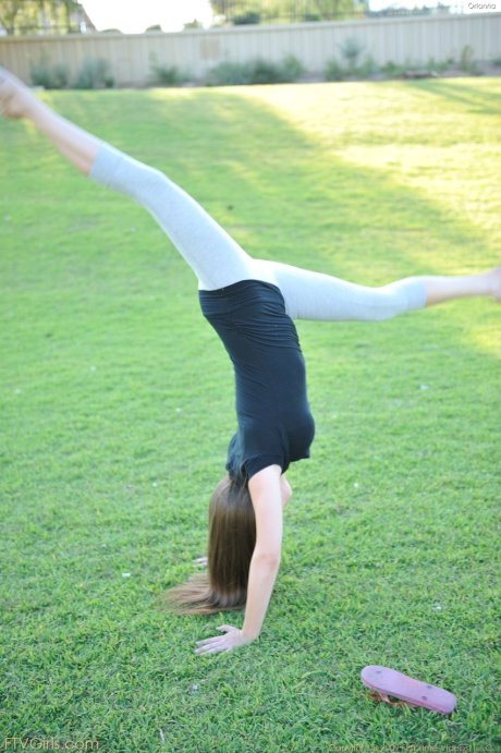 Amateur cutie with glasses Orianna gets naked while doing exercises outdoors