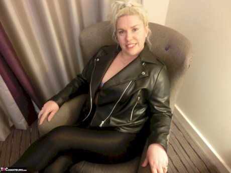 Mature blonde Barby strips to her heels before masturbating on a bed