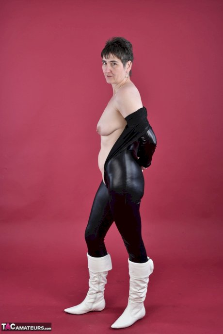 Solo model Hot MILF unzips a catsuit to expose her tits and twatin boots