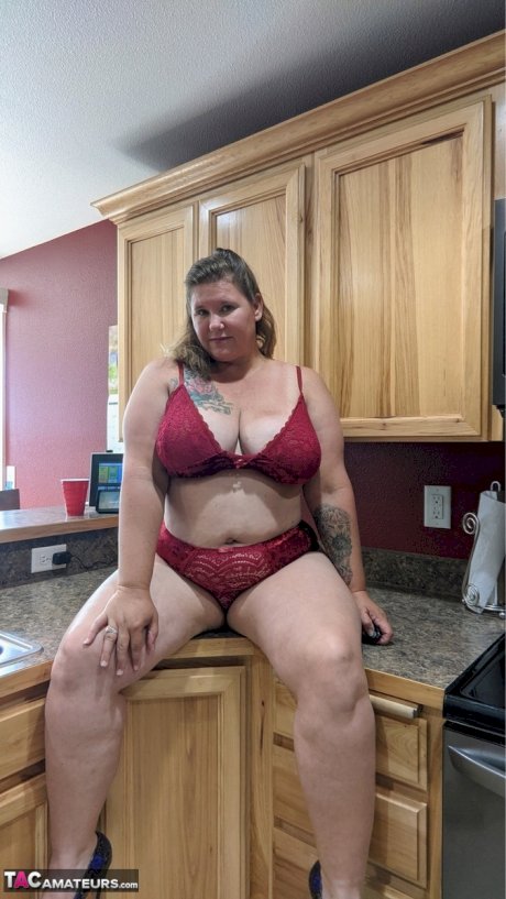 Amateur woman Busty Kris Ann shows her big tits and butt in her kitchen