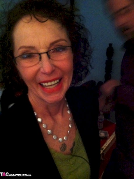 Curly haired mature woman likes sending her younger partner provocative photos