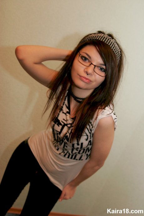 Young brunette Kaira 18 takes off her glasses while modelling non nude