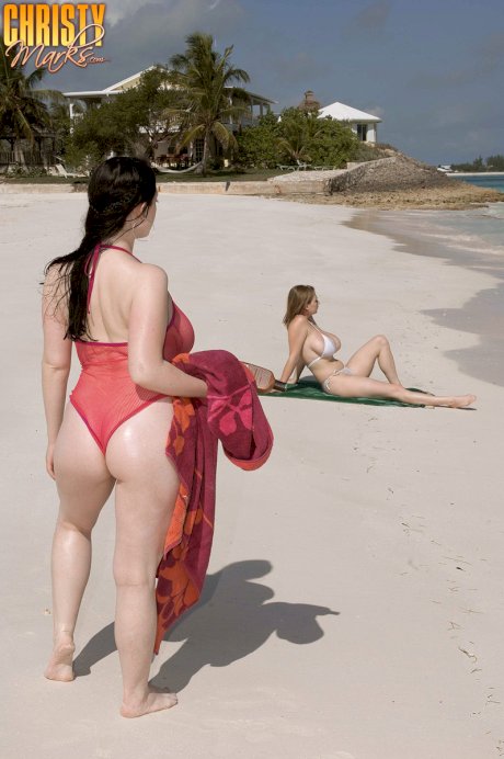 Plump female Christy Mark and her big boobed friend have lesbian sex on beach