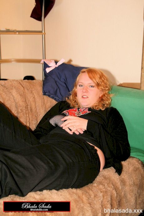 Redheaded fatty strips her sweatshirt and shows her cleavage in a black bra