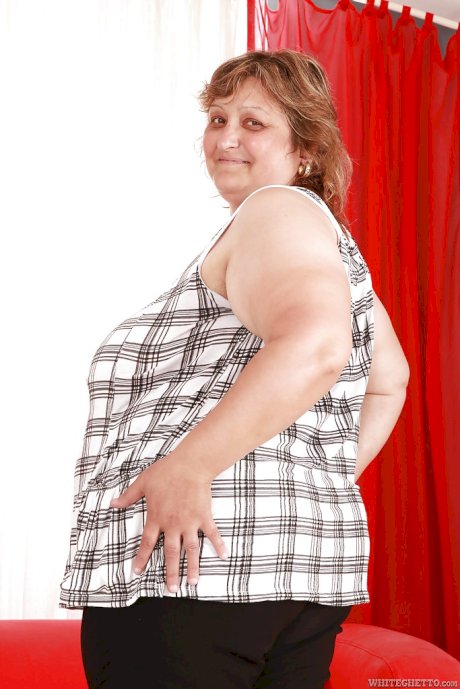 Fatty granny with huge boobs and ass stripping and spreading her legs