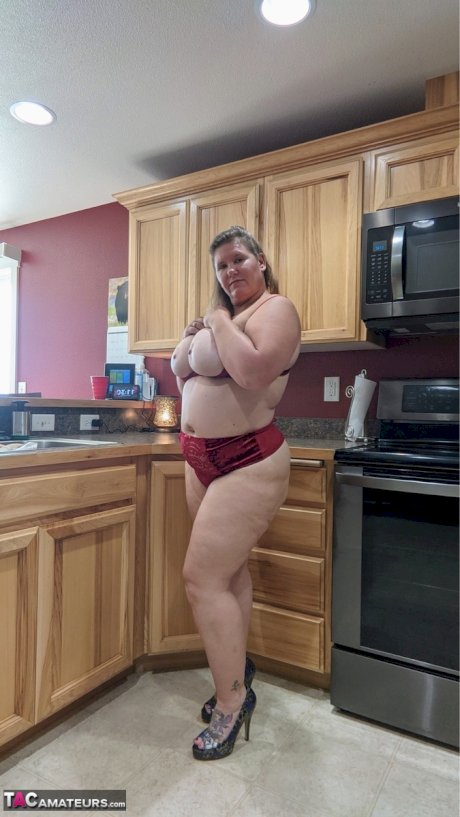 Amateur woman Busty Kris Ann shows her big tits and butt in her kitchen