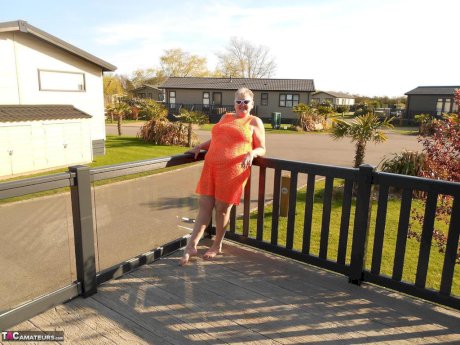 Fat nan bares her boobs while in a patio hot tub before getting naked on a bed