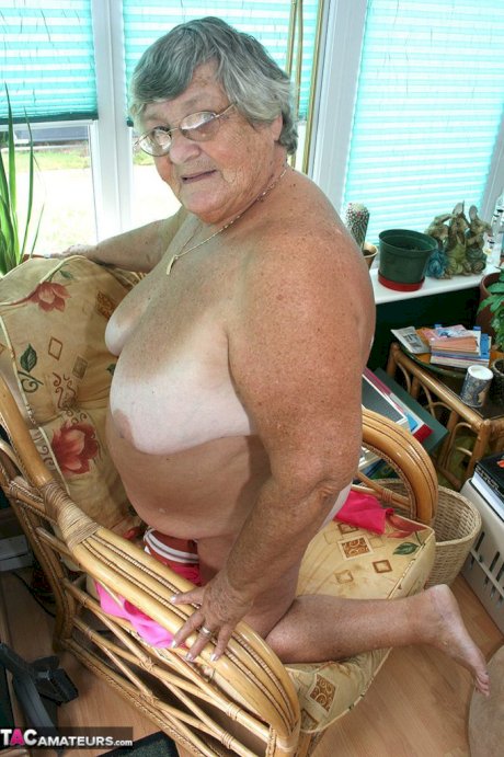 Horny old granny in glasses disrobes to reveal huge saggy tits & big BBW ass