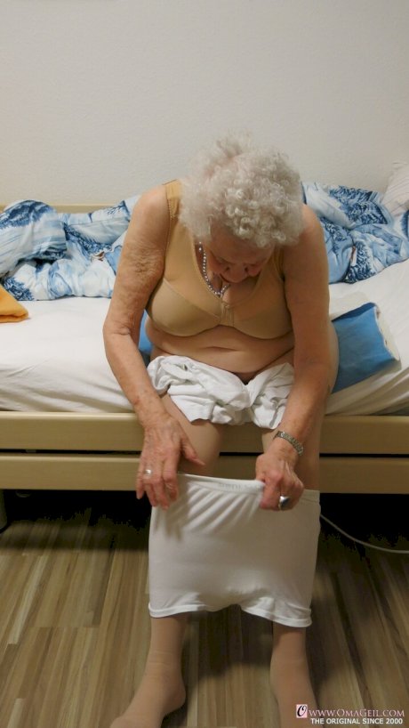 Kinky old granny Ornella poses naked and teases with her huge juggs