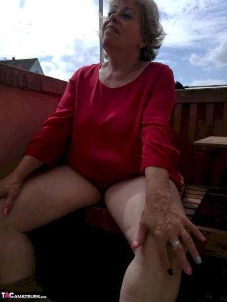 Horny oma spreads her upskirt pussy after pulling down her hose on patio