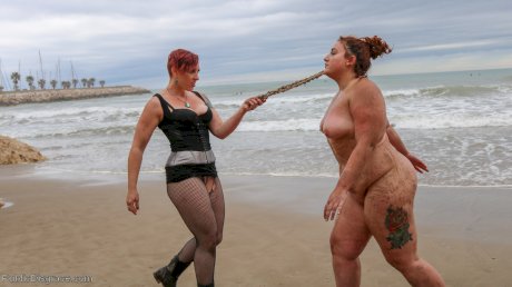 Slutty BBW Mimosa eats pussy while buried up to her neck in a kinky BDSM scene