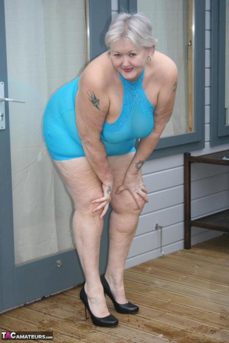 Fat granny hikes up see thru dress to expose her vagina in black pumps