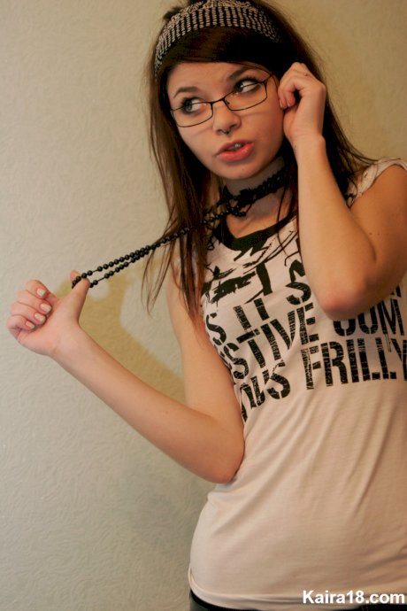 Young brunette Kaira 18 takes off her glasses while modelling non nude
