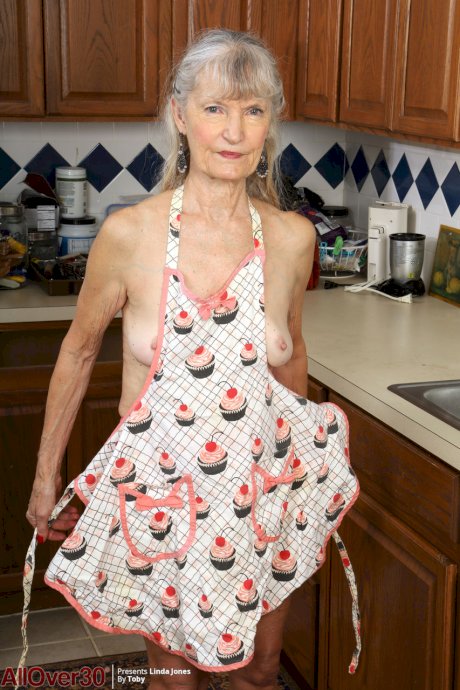 Old woman Linda Jones exposes her wrinkly body while cleaning her kitchen