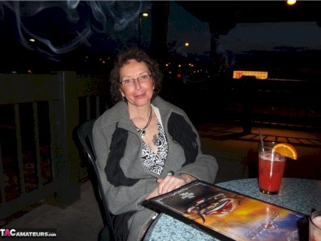 Curly haired mature woman likes sending her younger partner provocative photos