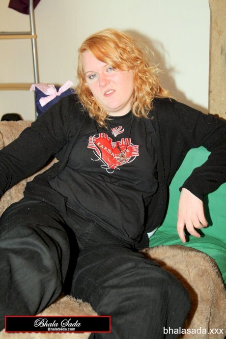 Redheaded fatty strips her sweatshirt and shows her cleavage in a black bra