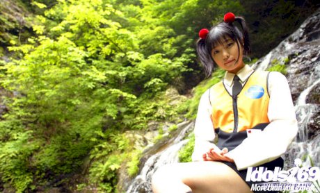 Smiley asian coed revealing her tiny titties and bushy cunt outdoor
