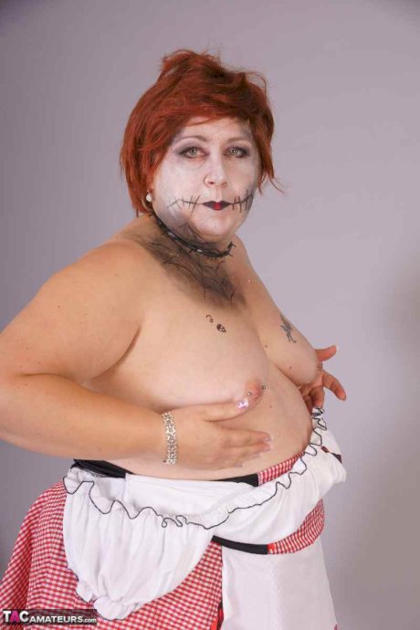 Redheaded BBW Lexie Cummings doffs cosplay wear to pose nude in mesh nylons
