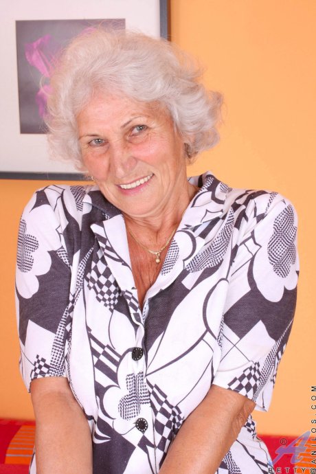 Grey haired granny Betty exposes her saggy juggs and fingers her clam