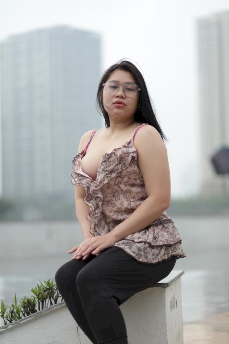 Beautiful chubby babe in glasses teases with her big boobs outdoors