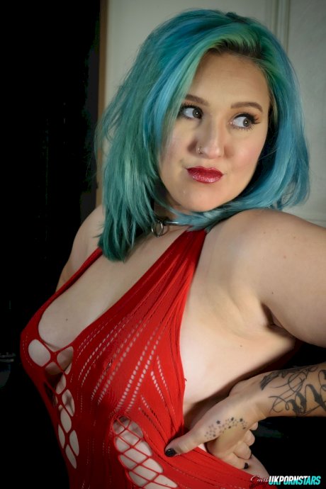 UK pornstar Ruby Fall lets her nipples slip free from a revealing red dress