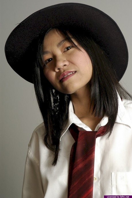 18 year old Asian girl makes her nude debut in a black hat and boots