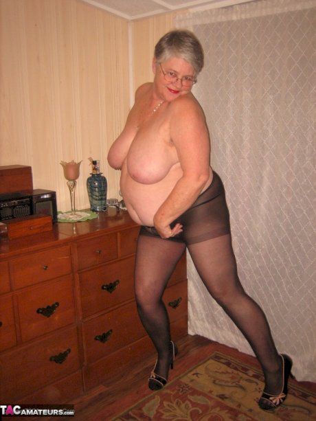 Overweight nan Girdle Goddess strips to her footwear in front of a dresser