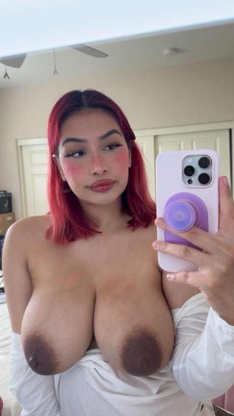 Buxom babe Angel shows her beautiful big boobs with dark nipples up close