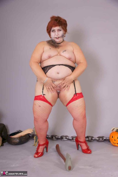 Redheaded BBW Lexie Cummings doffs cosplay wear to pose nude in mesh nylons