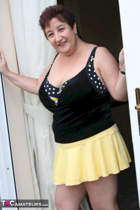 Fat older woman Kinky Carol flashes her bra and upskirt underwear on a patio