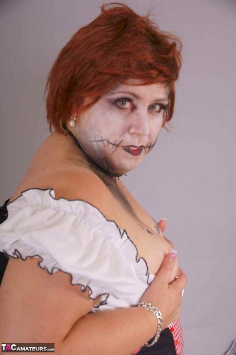 Redheaded BBW Lexie Cummings doffs cosplay wear to pose nude in mesh nylons