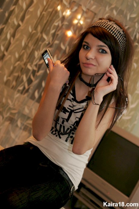 Young brunette Kaira 18 takes off her glasses while modelling non nude