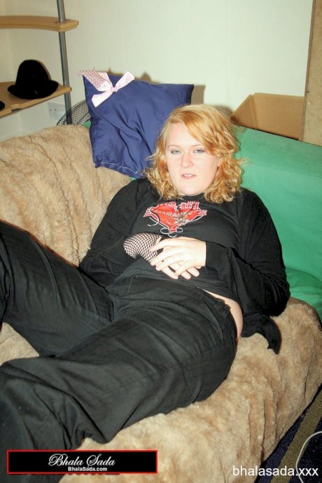 Redheaded fatty strips her sweatshirt and shows her cleavage in a black bra