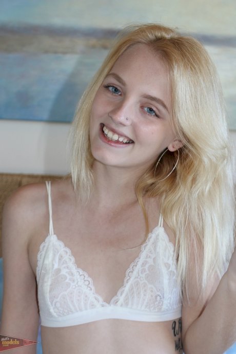 Petite blonde Kate Bloom parts her wet pussy after getting naked on her bed