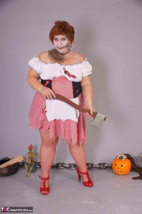 Redheaded BBW Lexie Cummings doffs cosplay wear to pose nude in mesh nylons