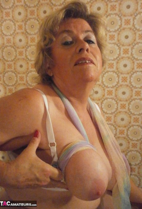 Old woman Caro shows her big natural tits in white pantyhose