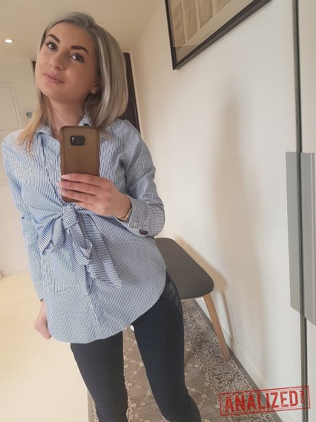 Amateur blonde Ari Fox reveals her small boobs and poses in front of a camera