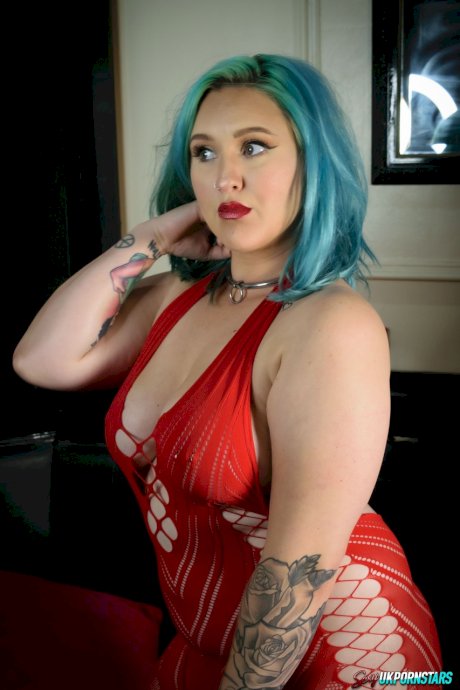 UK pornstar Ruby Fall lets her nipples slip free from a revealing red dress