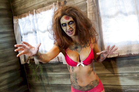 Saucy brunette cosplayer Kleio unveils her zombie tits and pussy