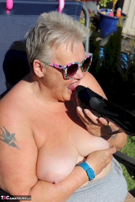 Fat nan Valgasmic Exposed licks a shoe while exposing herself in the backyard