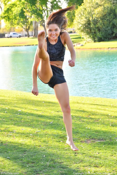 Teenage hottie in sexy outfit Zoe doing exercise outdoors by the water