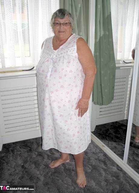 Old woman Grandma Libby grabs her fat roll after getting naked on a bed