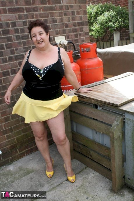 Fat older woman Kinky Carol flashes her bra and upskirt underwear on a patio