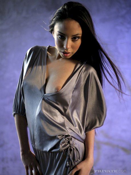 Exotic beauty Alexis Love slips off a silk robe and thong for nude poses