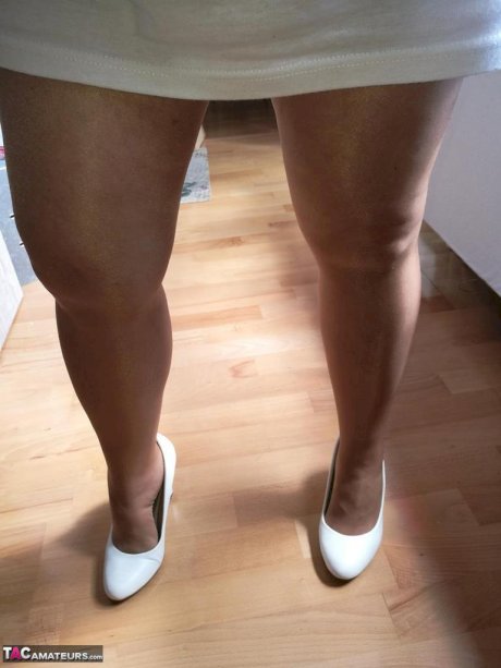 Horny grandmother slides hands down pantyhose to masturbate