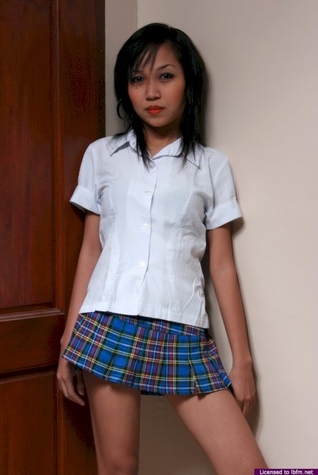 Asian schoolgirl stands naked up against the wall during her nude premiere